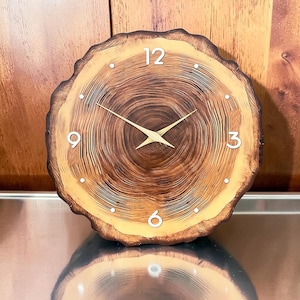 May include: A handmade wooden sign with the text "Welcome" in a handwritten style. The sign is painted white with a distressed finish, and a small green leaf is attached to the top. The sign measures approximately 12 inches wide.