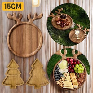 Puede incluir: Bandejas de madera para servir en varias formas, incluyendo una bandeja redonda con asas de cuernos (15 cm), y dos bandejas en forma de árbol de Navidad. Las bandejas están llenas de alimentos como frutas, nueces y queso.