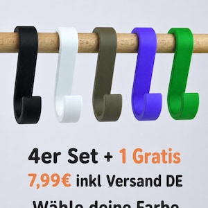 Könnte beinhalten: Fünf S-förmige Haken in Schwarz, Weiß, Olivgrün, Violett und Hellgrün hängen an einer Holzstange. Der Text darunter lautet 4er Set + 1 Gratis, 7,99€ inkl Versand DE und Wähle deine Farbe, was ein Set aus vier plus einem kostenlosen Haken beschreibt.