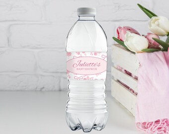 May include: Pink and white water bottle label with the text "Juliette's Baby Shower" in a pink oval. The label has a floral design with pink bows.