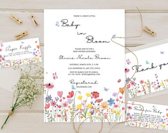 May include: A baby shower invitation with a floral theme. The invitation features a watercolor illustration of a field of flowers with butterflies. The text on the invitation reads "There's a sweet little Baby in Bloom" and includes the name "Olivia Nicole Brown".