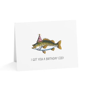 May include: A greeting card with a cartoon illustration of a fish wearing a party hat. The text on the card reads "I got you a birthday cod!"