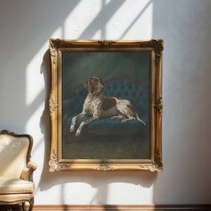 May include: A framed painting of a dog resting on a blue sofa. The dog has brown and white markings. The painting is in an ornate gold frame and hangs on a white wall.