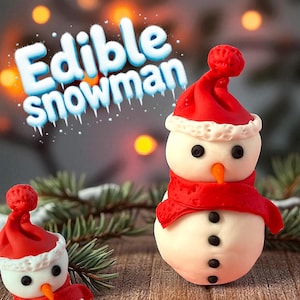 May include: Two edible snowman treats. Each snowman has a white body, black button eyes and a carrot nose. They wear a red hat and scarf. The text "Edible snowman" is above the snowmen.