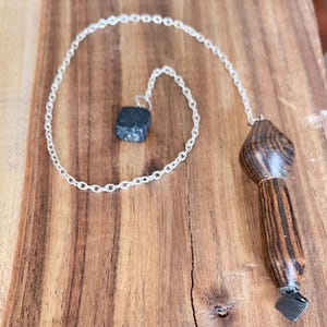 Acacia wood healing and divination pendulum made with copper and obsidian accents.