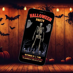 May include: A smartphone displays a Halloween Party invitation against a wooden backdrop with bats, pumpkins, and lights. The invitation features a skeleton, ghosts, and the text "Halloween Party" with the date and time.