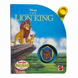 May include: A vintage Disney's The Lion King See 'n Say Storybook. The cover features Simba and Mufasa on a rock with a blue sky background. The book has a yellow handle and a sound button with a Simba graphic.