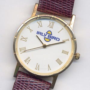 Reloj vintage con el logotipo de la ferretería Irly Bird, década de 1980
