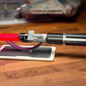 May include: A set of three ceramic mugs with a speckled, matte finish. The mugs are in shades of cream, light grey, and dark grey. Each mug has a simple, minimalist design, ideal for coffee or tea.