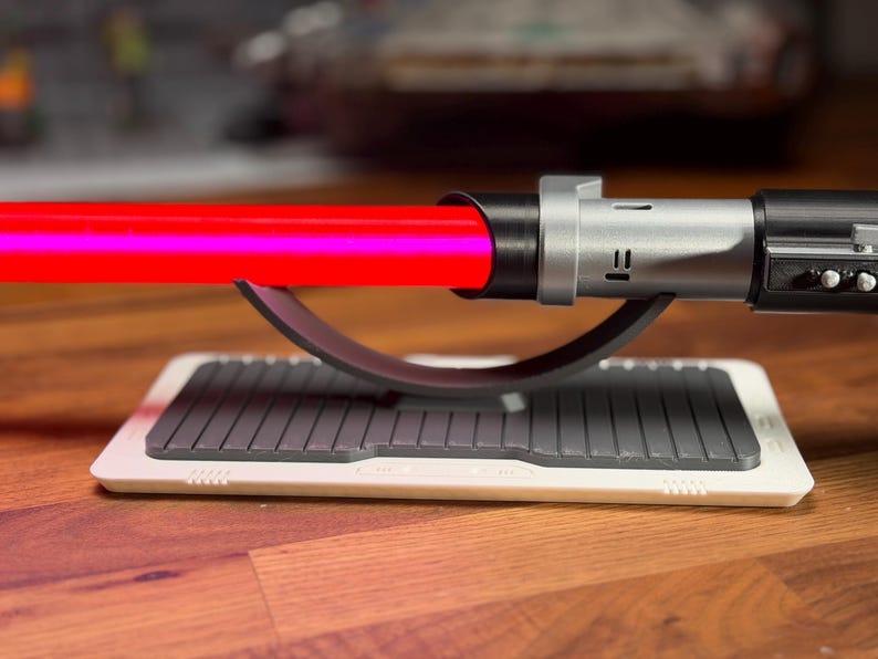 May include: A white ceramic mug with a black handle and the text "But first, coffee" in a black, handwritten-style font. The mug is on a white surface.