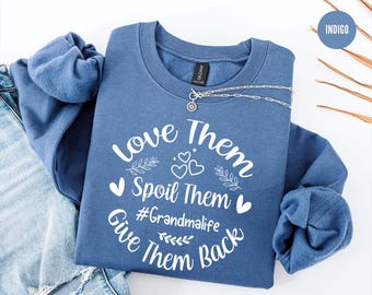 May include: Indigo blue sweatshirt with the text "Love Them Spoil Them #Grandmalife Give Them Back" in white. The sweatshirt has a white heart design and a white leaf design.