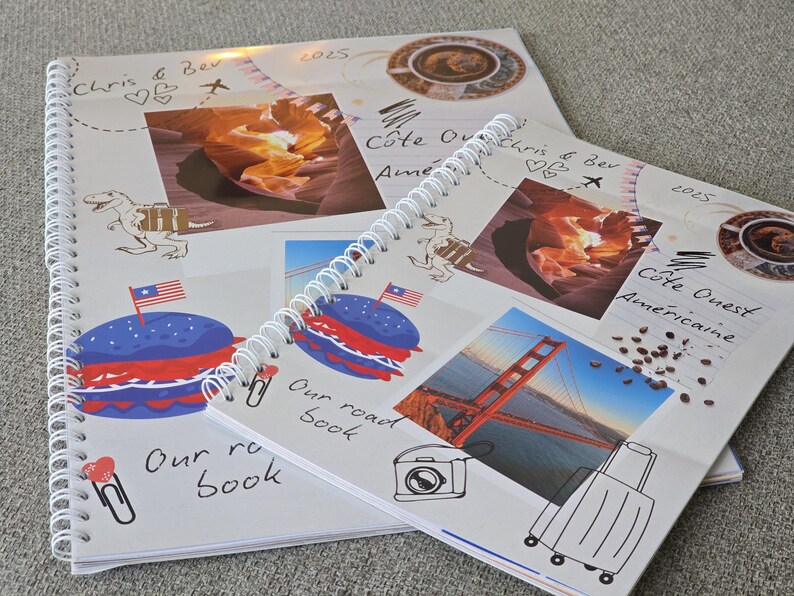 May include: Two white spiral bound notebooks with colorful images and handwritten text. The top notebook has a red, white, and blue burger, a dinosaur, and the text "Our road book". The bottom notebook has a photo of the Golden Gate Bridge, a suitcase, and the text "C&ocirc;te Quest Am&eacute;ricaine".