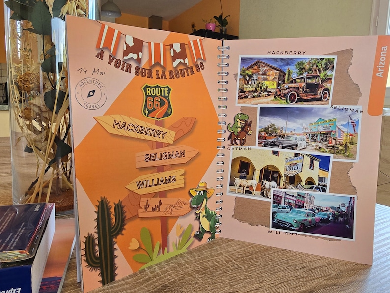 May include: A colorful travel journal with a Route 66 theme. The cover features a vintage Route 66 sign, a dinosaur, and a cactus. The inside pages have photos of various locations along Route 66, including Hackberry, Seligman, and Williams.