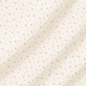 May include: A light cream-colored fabric featuring a repeating pattern of small, tan-colored horseshoe icons interspersed with tiny, pale blue butterfly motifs. The material is folded into diagonal pleats, creating a textured, layered appearance.