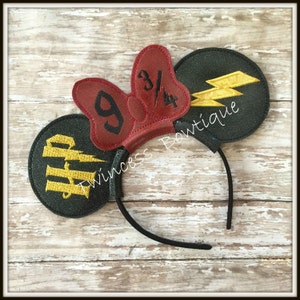 May include: Black headband with two black and green glitter mouse ears. One ear has a yellow lightning bolt and the other has a red bow with the numbers 9 3/4.