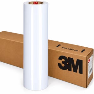 May include: A tall, cylindrical roll of glossy white adhesive film standing upright. The core of the roll features the red 3M logo. Behind the roll is a rectangular brown cardboard shipping box with the 3M logo and the text This side up printed.