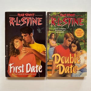 May include: Two paperback books from the Fear Street series by R.L. Stine. The book on the left is titled "First Date" and features a couple embracing. The book on the right is titled "Double Date" and features a couple sitting on a bench.