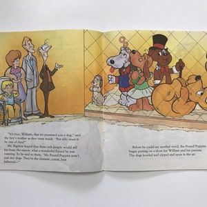 May include: A family visits a dog pound. The father, mother, and son are looking at a group of dogs behind a fence. The dogs are performing tricks. The text reads, "It's true, William, that we promised you a dog." and "Before he could say another word, the Pound Puppies began putting on a show for William and his parents. The dogs howled and yipped and spun in the air."