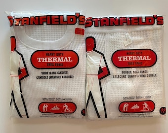 May include: Two packages of white thermal underwear, one labeled "Heavy Duty Thermal Tres Épais Shirt (Long Sleeves) Camisole (Manches Longues)" and the other labeled "Heavy Duty Thermal Tres Épais Double Seat Longs Caleçons Longs à Fond Double". Both packages feature a 50% cotton and 50% polyester blend.