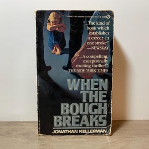 May include: A paperback book titled "When the Bough Breaks" by Jonathan Kellerman. The cover shows a child in blue jeans and a dark background with quotes from Newsday and The New York Times.