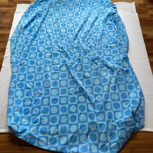 May include: A blue and white patterned bed sheet with a geometric design of circles and squares.