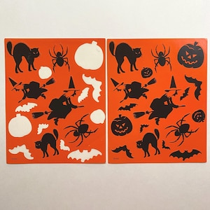 May include: Two sheets of orange Halloween stickers featuring black silhouettes of cats, bats, witches, spiders, pumpkins, and ghosts. The stickers are displayed against a white background.