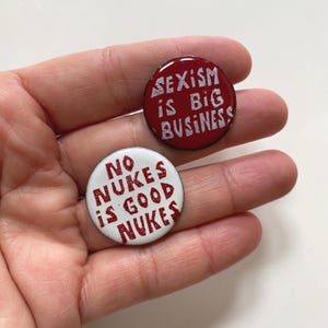 1960s Vintage Pinback Button Pin Badges Sexism is Big Business + No Nukes is Good Nukes Enamel Metal