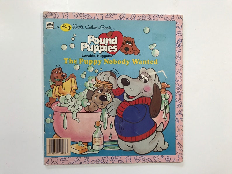 May include: A Big Little Golden Book featuring Pound Puppies, a series of lovable and huggable dogs. The cover shows a gray dog giving a bath to a brown dog in a pink bathtub. The book title is "The Puppy Nobody Wanted."