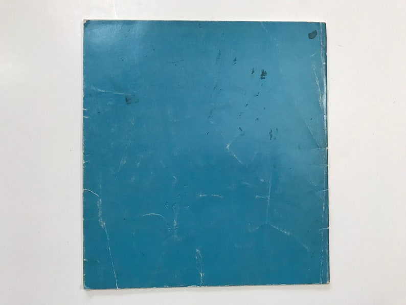 May include: A solid blue paper cover with some light scratches.