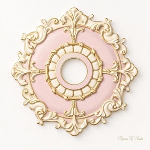 May include: A circular ceiling medallion featuring a soft pink center with an ornate cream and gold border. The outer edge is decorated with intricate scrollwork and leaf-like motifs. The text Marina R. Vladis is printed in the bottom right corner.