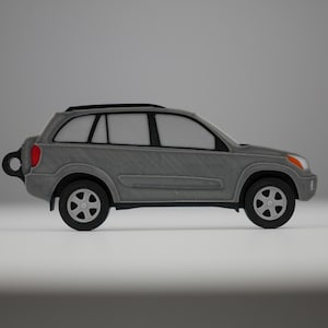 May include: A gray SUV model with black wheels and a black roof rack. The vehicle has a red taillight and orange headlights. The car is a miniature replica of a real-life vehicle.