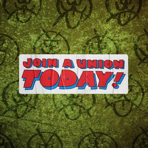May include: A white sign with blue and red lettering that reads "Join a Union Today!" The sign is on a green background with black scribbles.