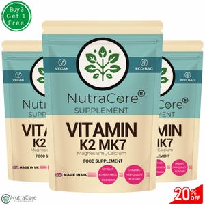 May include: Three pouches of NutraCore Vitamin K2 MK7 supplement. The pouches are teal and beige with the words "Vitamin K2 MK7" and "Food Supplement" printed on them. The pouches also have the words "Vegan", "Eco Bag", and "Made in UK" printed on them. A green circle with the words "Buy 3 Get 1 Free" is in the upper left corner.