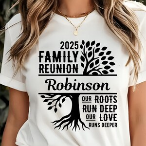 May include: White t-shirt with black text and a tree graphic. The text reads "2025 Family Reunion Robinson" above a tree design, with the words "Our Roots Run Deep, Our Love Runs Deeper" below.