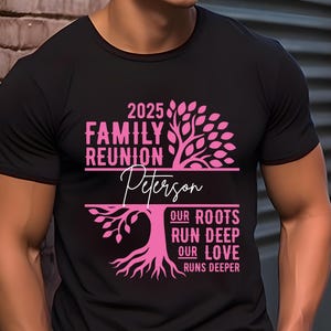 May include: Black t-shirt with a pink family reunion design. The design includes the text "2025 Family Reunion Peterson" with a tree graphic and the words "Our Roots Run Deep, Our Love Runs Deeper."