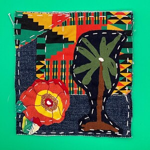 May include: A square fabric art piece with a denim base, featuring a colorful patchwork design. It includes a red and yellow flower, a black palm tree, and a section of patterned fabric in red, yellow, black, and green. White stitching outlines the shapes.
