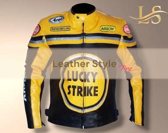 May include: A yellow and black leather motorcycle jacket with the text "LUCKY STRIKE" on the back. The jacket has black and silver stripes across the chest and shoulders, and patches with the words "Arai", "Michelin", and "Arrow".