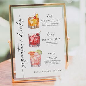 May include: A gold-framed sign features three cocktail illustrations: an Old Fashioned, a Dirty Shirley, and a Paloma. The sign details ingredients for each drink, with "Signature Drinks" written in a decorative script.