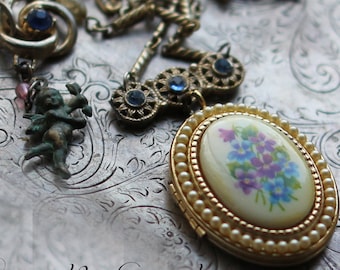 Forget Me Not ~ vintage assemblage locket necklace one of a kind blue rhinestones floral forget me nots violets angel crowned by grace
