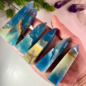 Vivid sky blue with white and brown banding Blue Onyx points or towers average height is about three inches