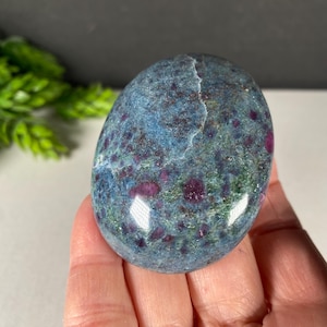 May include: A set of three ceramic mugs with a speckled, matte finish. The mugs are in shades of cream, light gray, and dark gray. Each mug has a simple, minimalist design, perfect for coffee or tea.