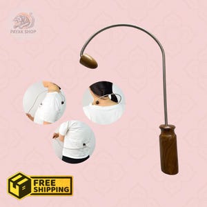 May include: A brown and silver self-massager tool with a curved design. The tool has a wooden handle and a wooden massage head. The image also shows how the tool is used on the back and neck. The image includes the text "FREE SHIPPING".