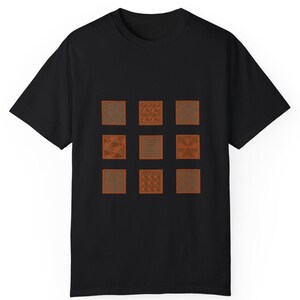 May include: Black t-shirt with a design of nine orange squares, each with a different geometric pattern.