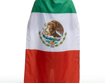 May include: A cape featuring the Mexican flag design. The cape is divided into three horizontal stripes of green, white, and red. The white stripe features the Mexican coat of arms, a detailed emblem of an eagle with a snake.