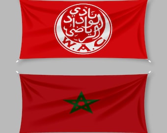 May include: Two red flags. The top flag features a white emblem with Arabic script and the letters "W.A.C." The bottom flag is red with a green star in the center. Both flags are hanging.