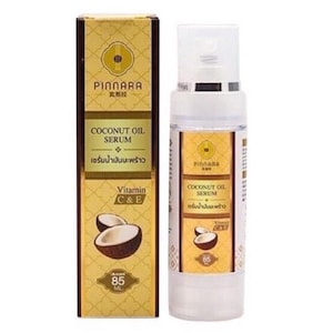 May include: A white and gold bottle of Pinnara Coconut Oil Serum with a matching box. The box and bottle feature the product name, ingredients, and a graphic of coconuts. The bottle contains 85 ml of serum.