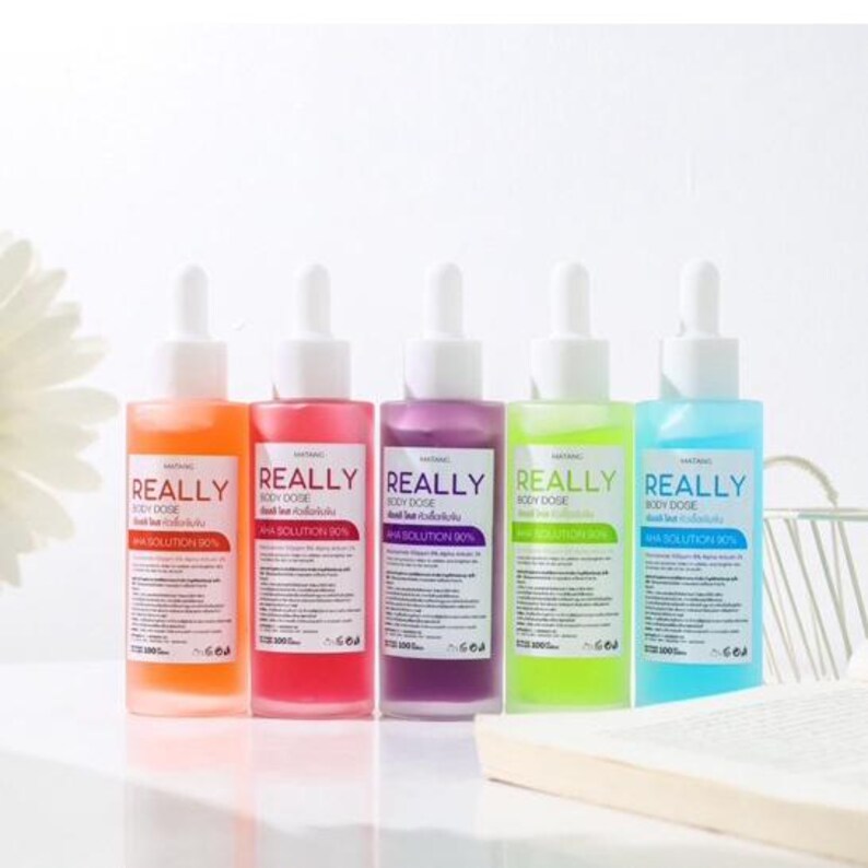 May include: Five bottles of body dose solution in orange, pink, purple, green, and blue. Each bottle has a white dropper and a white label with the word "REALLY" in large letters. The text "BODY DOSE" and "AHA SOLUTION 90%" are also visible.