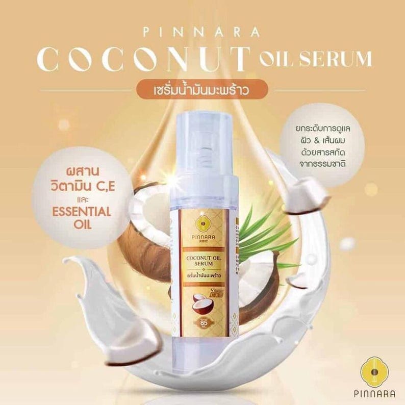 May include: A product advertisement for Pinnara Coconut Oil Serum. The image features a clear bottle of serum with a white and gold label, set against a backdrop of coconuts, coconut milk, and text in English and Thai. The text highlights the serum's ingredients and benefits.