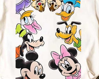 May include: White t-shirt featuring a colorful graphic of Disney cartoon characters, including Mickey Mouse, Minnie Mouse, Donald Duck, and Goofy. The shirt has a crew neck and short sleeves, perfect for casual wear.