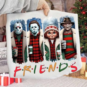 May include: White pillowcase featuring four horror movie characters with coffee cups, in a winter scene. The characters are Jason, Michael Myers, Chucky, and Freddy Krueger. The word "FRIENDS" is written across the bottom in colorful letters.